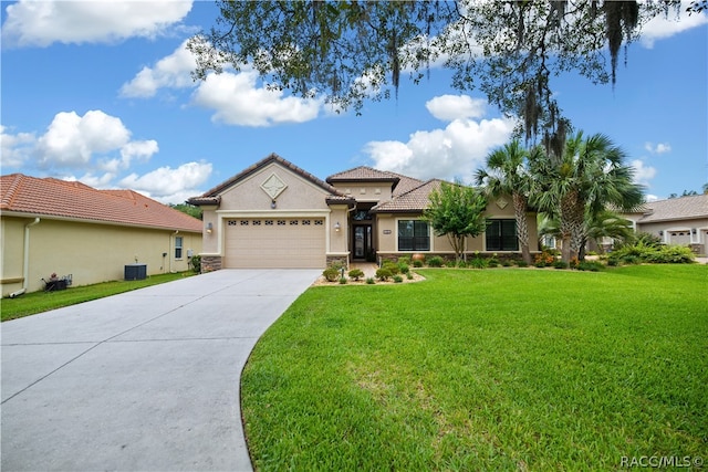 view of front of house with cooling unit, a front lawn, and a garage