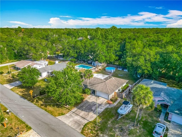 birds eye view of property with a view of trees