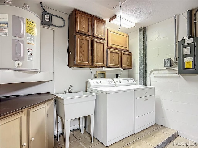 clothes washing area featuring cabinet space, separate washer and dryer, concrete block wall, light tile patterned floors, and electric panel