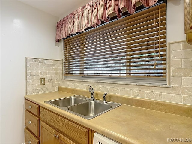 kitchen featuring a sink and light countertops