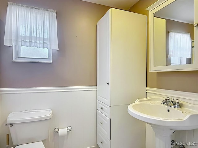 half bathroom with a sink and toilet