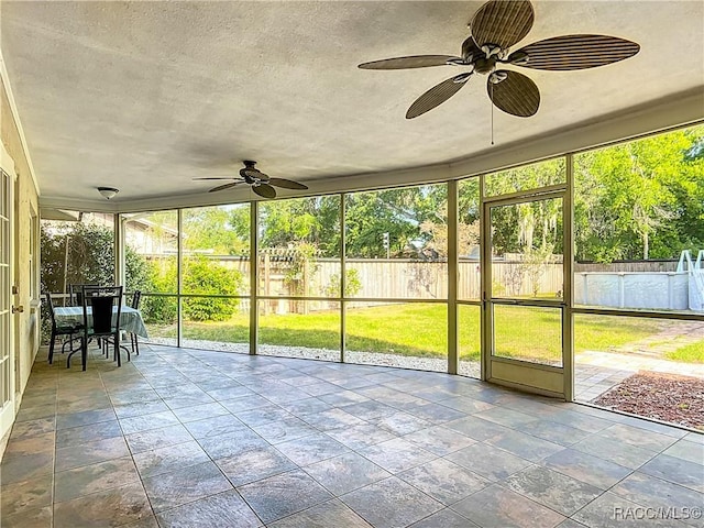 sunroom with a ceiling fan