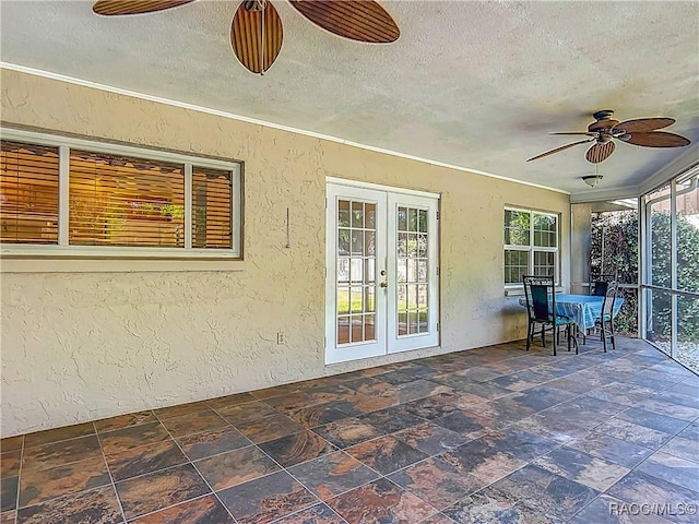 sunroom / solarium with french doors, a textured ceiling, and a textured wall