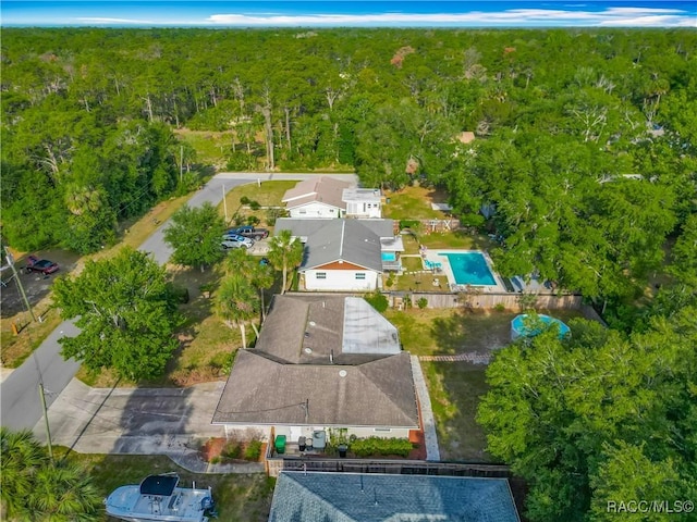 bird's eye view featuring a wooded view