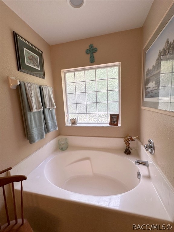 bathroom featuring a tub to relax in