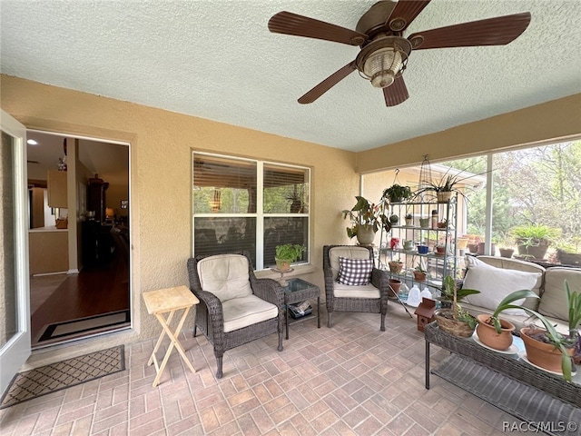 sunroom / solarium with ceiling fan and plenty of natural light