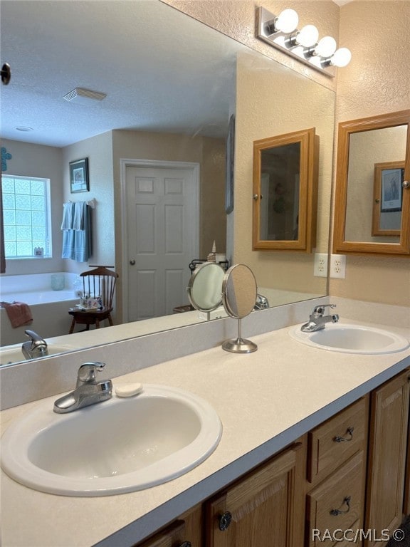 bathroom featuring vanity and a tub