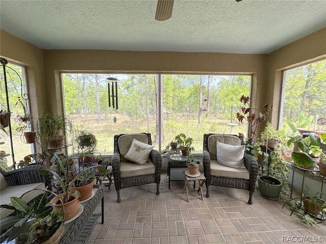 sunroom / solarium with ceiling fan and plenty of natural light