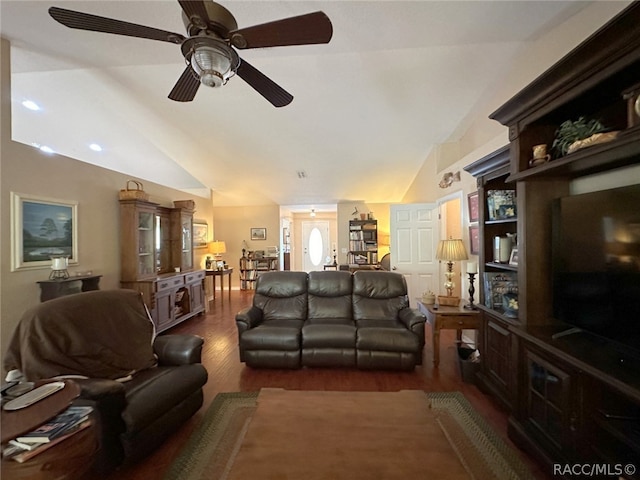 living room with ceiling fan, dark hardwood / wood-style flooring, and vaulted ceiling