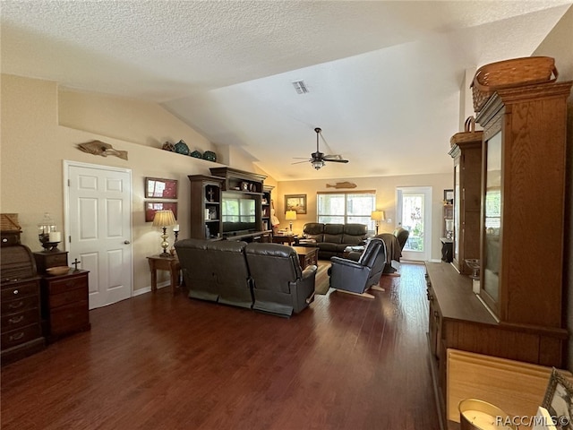 living room featuring a textured ceiling, ceiling fan, dark hardwood / wood-style flooring, and lofted ceiling