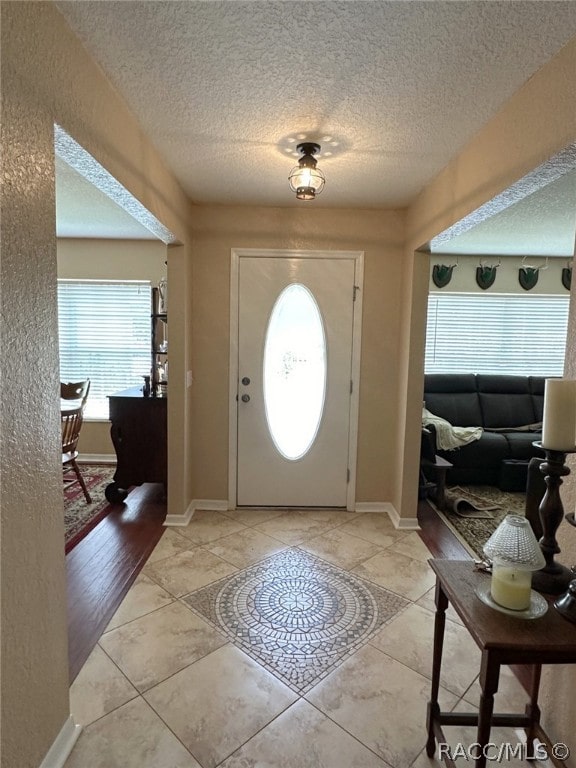 entryway featuring light hardwood / wood-style flooring and a textured ceiling