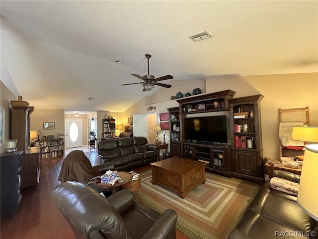 living room featuring a textured ceiling, ceiling fan, dark hardwood / wood-style floors, and vaulted ceiling