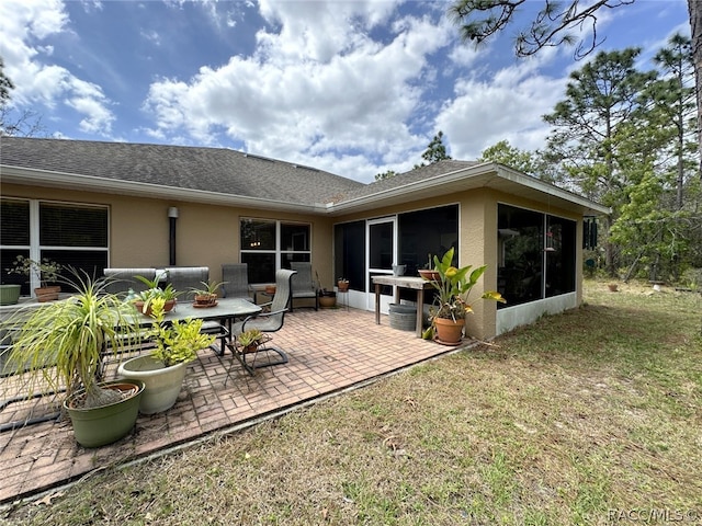 back of house with a sunroom and a patio area