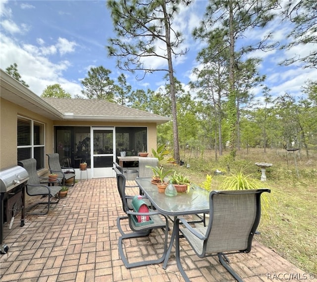 view of patio featuring a sunroom