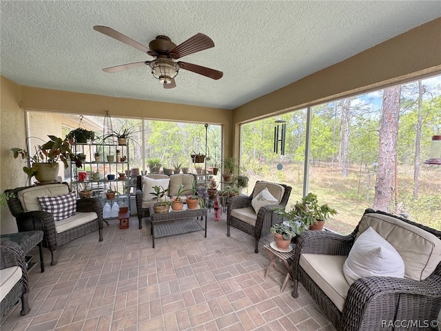 sunroom / solarium featuring ceiling fan