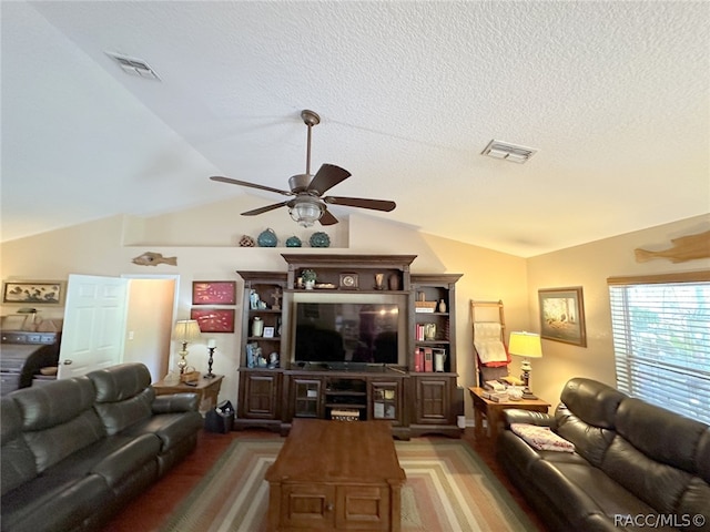 carpeted living room featuring a textured ceiling, ceiling fan, and lofted ceiling