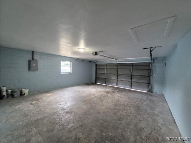 garage featuring electric panel and a garage door opener