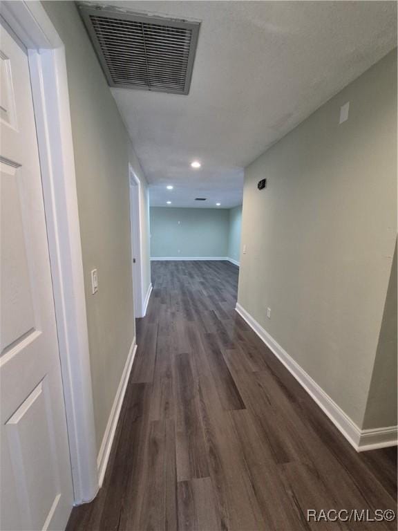 corridor with dark hardwood / wood-style floors