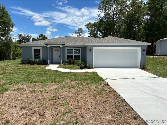 ranch-style house with a garage, stucco siding, a front yard, and driveway