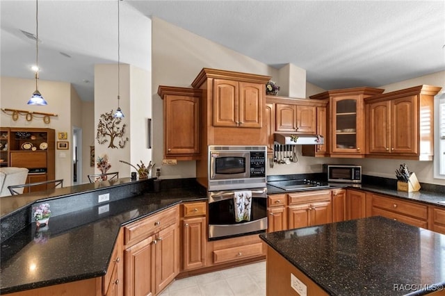 2168 N Watersedge Dr, Crystal River, FL 34429 - kitchen with appliances with stainless steel finishes, a peninsula, glass insert cabinets, dark stone counters, and vaulted ceiling