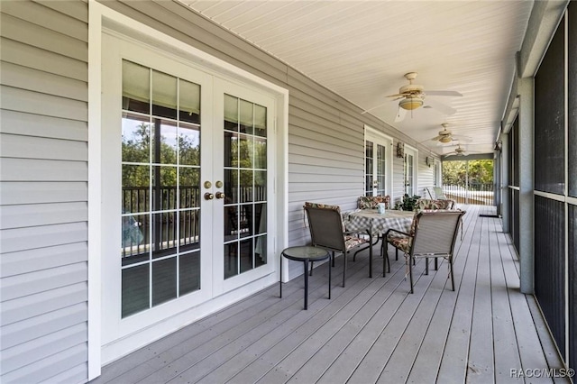 2168 N Watersedge Dr, Crystal River, FL 34429 - wooden deck featuring french doors, a ceiling fan, and outdoor dining area