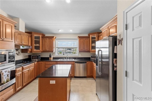 2168 N Watersedge Dr, Crystal River, FL 34429 - kitchen with stainless steel appliances, under cabinet range hood, a kitchen island, glass insert cabinets, and recessed lighting