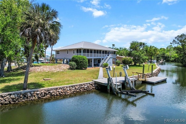 2168 N Watersedge Dr, Crystal River, FL 34429 - dock with a water view, boat lift, stairs, and a lawn