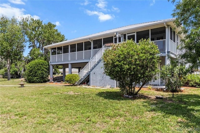 2168 N Watersedge Dr, Crystal River, FL 34429 - back of house with a sunroom, a lawn, stairs, and a metal roof