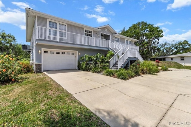 2168 N Watersedge Dr, Crystal River, FL 34429 - view of front facade with an attached garage, concrete driveway, and stairway