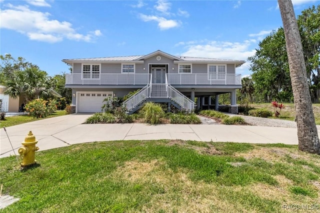 2168 N Watersedge Dr, Crystal River, FL 34429 - view of front of home featuring driveway, covered porch, stairs, a garage, and a front lawn