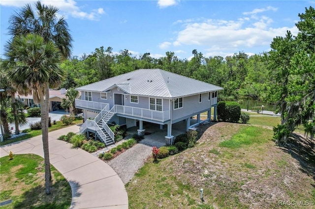 2168 N Watersedge Dr, Crystal River, FL 34429 - view of front of house featuring gravel driveway, a metal roof, stairs, and a carport