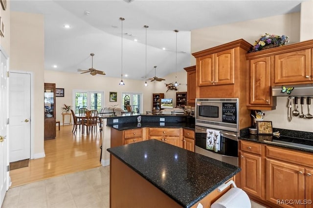 2168 N Watersedge Dr, Crystal River, FL 34429 - kitchen featuring appliances with stainless steel finishes, a peninsula, vaulted ceiling, a ceiling fan, and brown cabinets