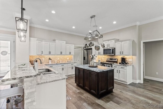 5888 W Corral Pl, Beverly Hills, FL 34465 - kitchen featuring appliances with stainless steel finishes, a sink, a peninsula, white cabinetry, and recessed lighting