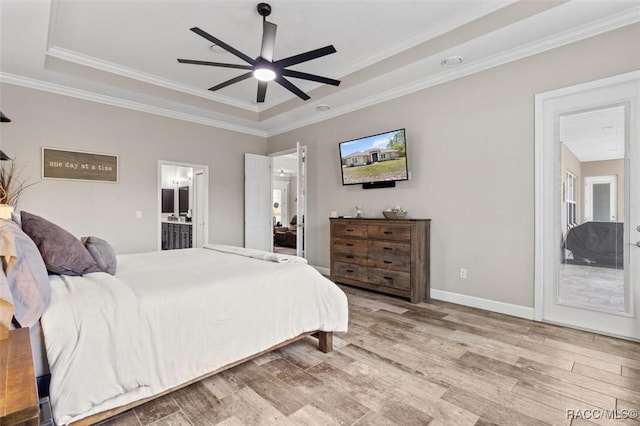 5888 W Corral Pl, Beverly Hills, FL 34465 - bedroom with a tray ceiling, wood finished floors, ornamental molding, ensuite bath, and a ceiling fan