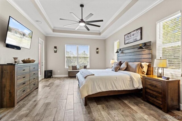 5888 W Corral Pl, Beverly Hills, FL 34465 - bedroom featuring a tray ceiling, wood finished floors, crown molding, ceiling fan, and baseboards