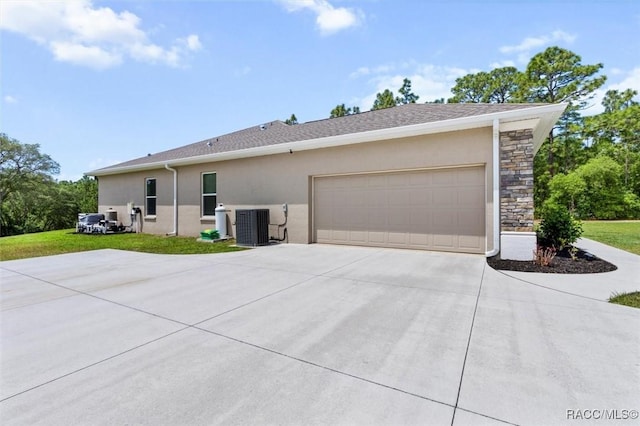 5888 W Corral Pl, Beverly Hills, FL 34465 - view of front of property featuring concrete driveway, an attached garage, stucco siding, and stone siding
