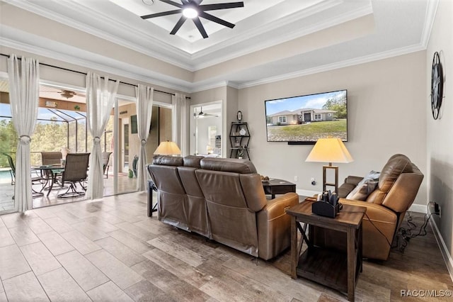 5888 W Corral Pl, Beverly Hills, FL 34465 - living room with ceiling fan, a tray ceiling, ornamental molding, wood finished floors, and baseboards