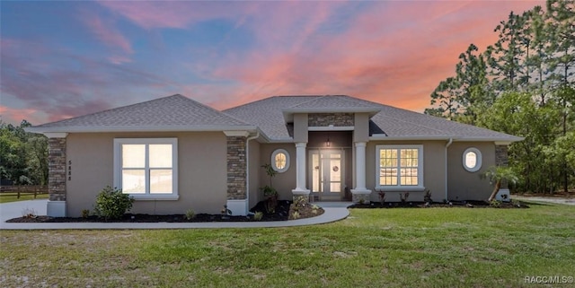 5888 W Corral Pl, Beverly Hills, FL 34465 - view of front of house with stucco siding, a front lawn, and stone siding