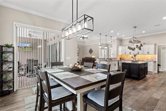 5888 W Corral Pl, Beverly Hills, FL 34465 - dining room featuring light wood-style floors, recessed lighting, a chandelier, crown molding, and ceiling fan