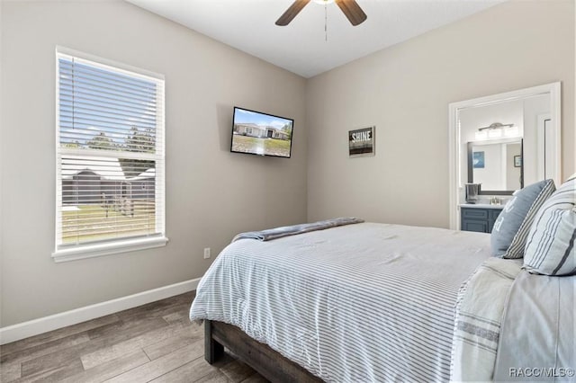 5888 W Corral Pl, Beverly Hills, FL 34465 - bedroom with wood finished floors, baseboards, connected bathroom, and ceiling fan