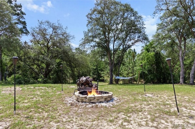 5888 W Corral Pl, Beverly Hills, FL 34465 - view of grassy yard with an outdoor fire pit