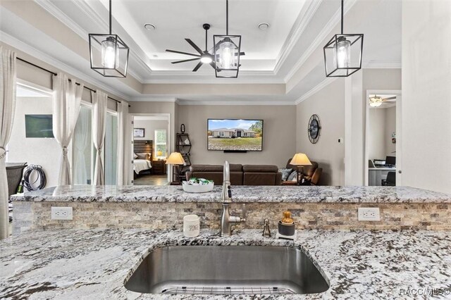 5888 W Corral Pl, Beverly Hills, FL 34465 - kitchen featuring a sink, ceiling fan, light stone counters, a raised ceiling, and ornamental molding