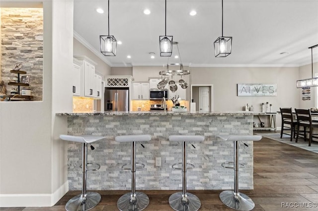 5888 W Corral Pl, Beverly Hills, FL 34465 - bar area with appliances with stainless steel finishes, dark wood finished floors, recessed lighting, ornamental molding, and hanging light fixtures