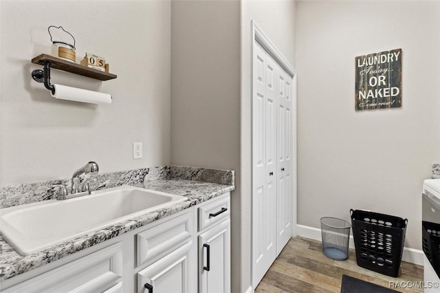 5888 W Corral Pl, Beverly Hills, FL 34465 - laundry area with a sink, light wood finished floors, and baseboards