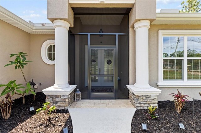 5888 W Corral Pl, Beverly Hills, FL 34465 - entrance to property featuring stucco siding, stone siding, and french doors