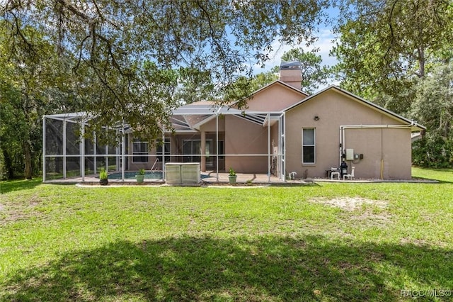 4491 W Stable Ct, Beverly Hills, FL 34465 - back of property with a pool, stucco siding, a lawn, a chimney, and a patio