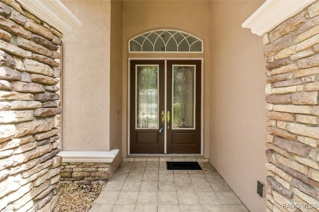 4491 W Stable Ct, Beverly Hills, FL 34465 - doorway to property featuring french doors and stucco siding