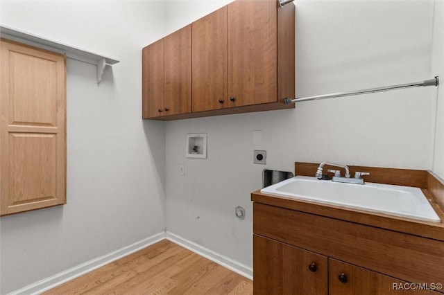 4491 W Stable Ct, Beverly Hills, FL 34465 - laundry area featuring electric dryer hookup, cabinet space, light wood-style floors, and hookup for a washing machine