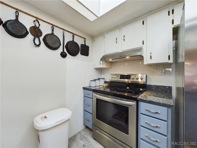 kitchen with backsplash, dark stone countertops, range hood, white cabinetry, and stainless steel appliances