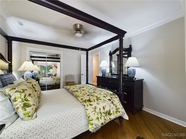 bedroom with ceiling fan, dark hardwood / wood-style flooring, and ornamental molding